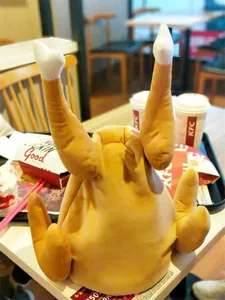 Close-up view of a plush electric dancing turkey hat for Thanksgiving holiday fun