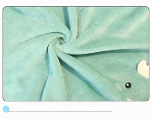 Close-up of soft mint green flannel blanket showing plush texture and storage strap.