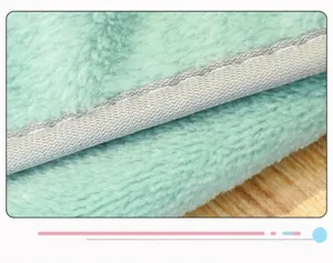Macro detail of a soft green flannel blanket showing high-quality durable stitching edges