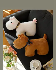 Macro view of white and brown plush dog toys with stylish bow ties on a black sofa