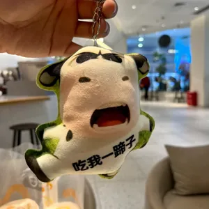 Detail view of a funny abstract cow plush keychain with humorous facial expression