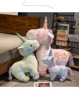 Dreamy rainbow tie-dye standing unicorn plush toys displayed in cozy home setting