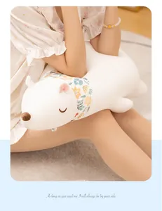 Detailed view of soft plush polar bear toy pillow with a cute floral neck scarf detail
