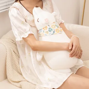 Soft white polar bear plush toy pillow held by a girl in a cozy room
