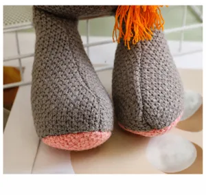Gros plan détaillé montrant la texture tricotée et le rembourrage doux de la peluche