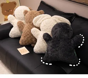 Variety of cozy animal-shaped plush stress-relief pillows displayed on a black leather sofa