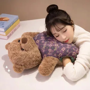 Ultra soft plush bear hand warmer pillow featuring floral pattern and pocket design