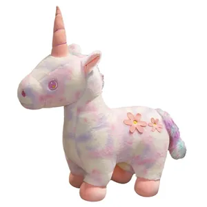 Soft colorful tie-dye plush unicorn toy featuring pink flowers and a fluffy rainbow tail