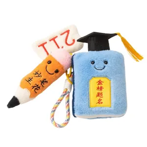 Creative plush graduation keychain with smiling pencil and book charms