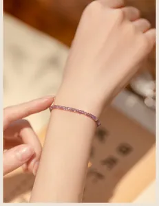 Elegant close-up view of a minimalist 2mm natural lavender amethyst bead bracelet