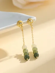 Close-up of golden drop ear clips with gradient green jade beads for non-pierced ears