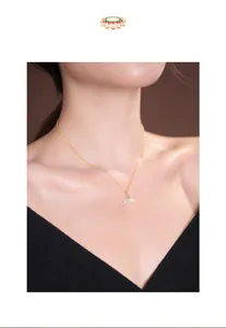 Close-up of S925 silver necklace with pale green jade fish tail pendant on female model.