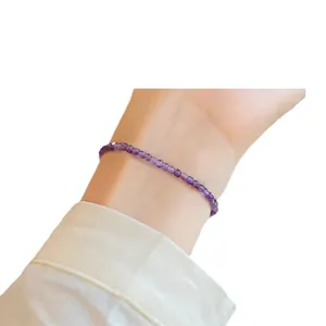 Handmade minimalist 2mm natural lavender amethyst beaded bracelet worn on a model's wrist