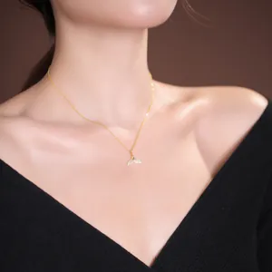 Elegant gold-plated S925 silver necklace with white jade fishtail pendant on a model