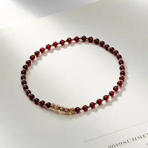 Natural red garnet anklet with 14K gold-filled beads on a minimalist white background.