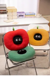 Collection of three apple-shaped cat plush cushions in red, yellow, and green colors on chairs