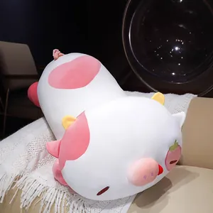 Cute strawberry cow plush toy large sleeping pillow doll on a cozy sofa