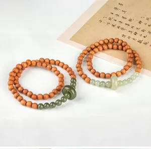 Detail of sandalwood double-loop bracelets with green jade rings in Chinese style