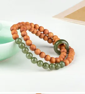Detailed close-up of a sandalwood and green jade double-loop bracelet in Chinese style
