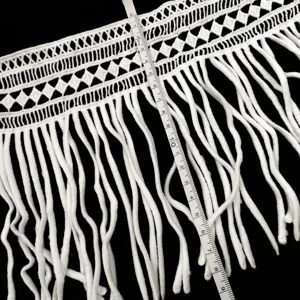 Detailed view of white milk silk fringe lace trim with measuring tape showing size