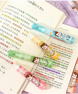 Close-up of cute glitter highlighters with anime girl illustration on an open book