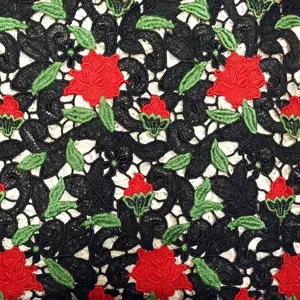 Heavy embroidered water soluble lace fabric with 3D red rose floral and leaf patterns.