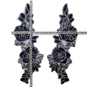 Detailed view showing measurements of black floral embroidered lace patches on organza.