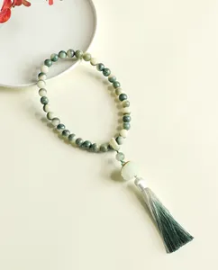 Traditional green Bodhi seed bead bracelet with carved lotus charm and long silk tassel