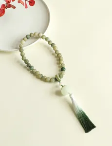 Detailed view of Chinese style lotus Bodhi prayer beads with a green gradient tassel
