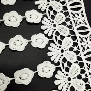 Close-up of white water-soluble milk silk embroidery lace trim with floral patterns