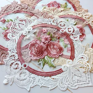 Close-up of intricate rose embroidered lace patches showing detailed floral stitching