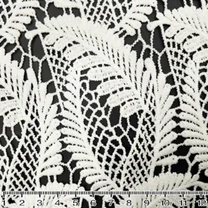 Detailed close-up view of white water-soluble lace fabric with milk silk hollow leaf embroidery