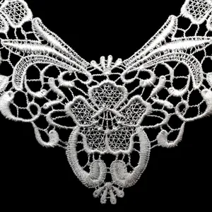 Close-up detail of white water-soluble lace collar with intricate floral embroidery