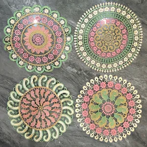 Detailed view of four colorful circular embroidered lace placemats with intricate floral patterns