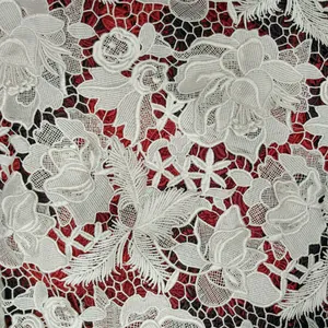 Detailed view of 3D hollow-out water-soluble lace fabric with floral and feather embroidery