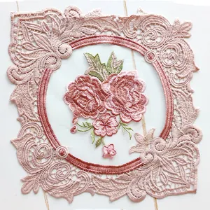 Close-up of embroidered rose pattern on lace placemat coaster