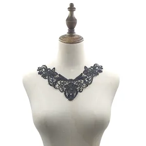 Close-up view of black water-soluble floral lace collar applique on a white mannequin torso