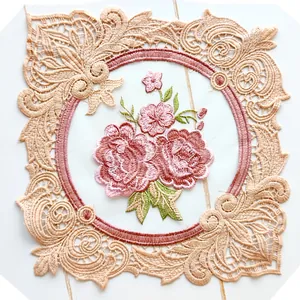 Close-up of elegant floral embroidery with intricate beige lace border