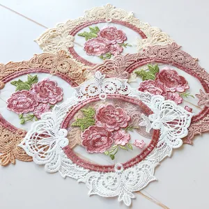 Close-up of elegant floral embroidery table mats with lace borders