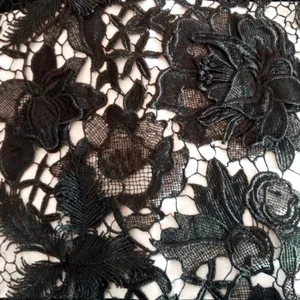 Close-up detail of black water-soluble lace with 3D hollow floral embroidery texture
