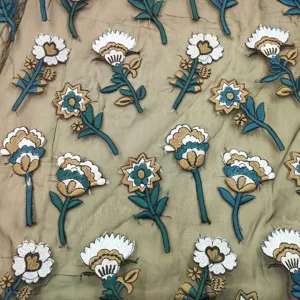 Detailed view showing colorful heavy floral embroidery on tan organza mesh fabric