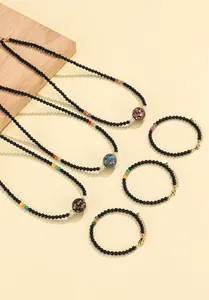 Handcrafted black agate beaded jewelry set with traditional lacquer pattern beads