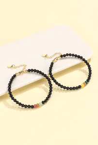 Detailed view of handmade black agate bracelets featuring colorful gemstone beads and gold clasp