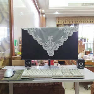 Grey embroidered lace cover cloth draped elegantly on a computer monitor screen display