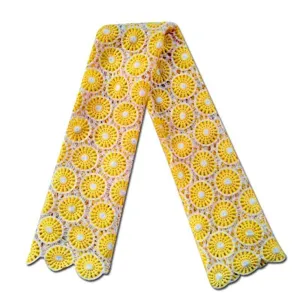 Detailed view of yellow and white two-tone water-soluble lace fabric with hollow floral design