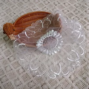 Close-up of white organza embroidered lace table mat with sunflower pattern design