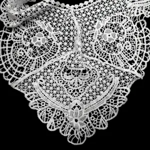 Detail of white embroidered lace Hanfu capelet showing intricate hollow-out floral patterns