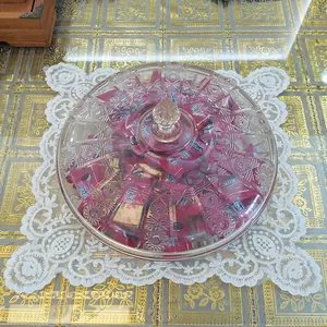 Detailed top view of a white embroidered lace placemat featuring intricate hollow floral patterns