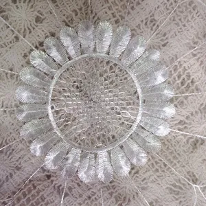 Macro detail of white organza embroidered lace coaster with elegant sunflower floral pattern