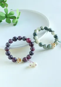 Engraved Six-Syllable Mantra Bodhi seed bracelet with cat paw charm detail
